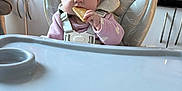 Danni-Rae is registered to the contest to win money with this photo: baby, biscuit, child, clothing, domestic, eating, expression, face, feeding, food, high_chair, household, indoor, infant, kitchen, person, plastic, seat, table, utensil