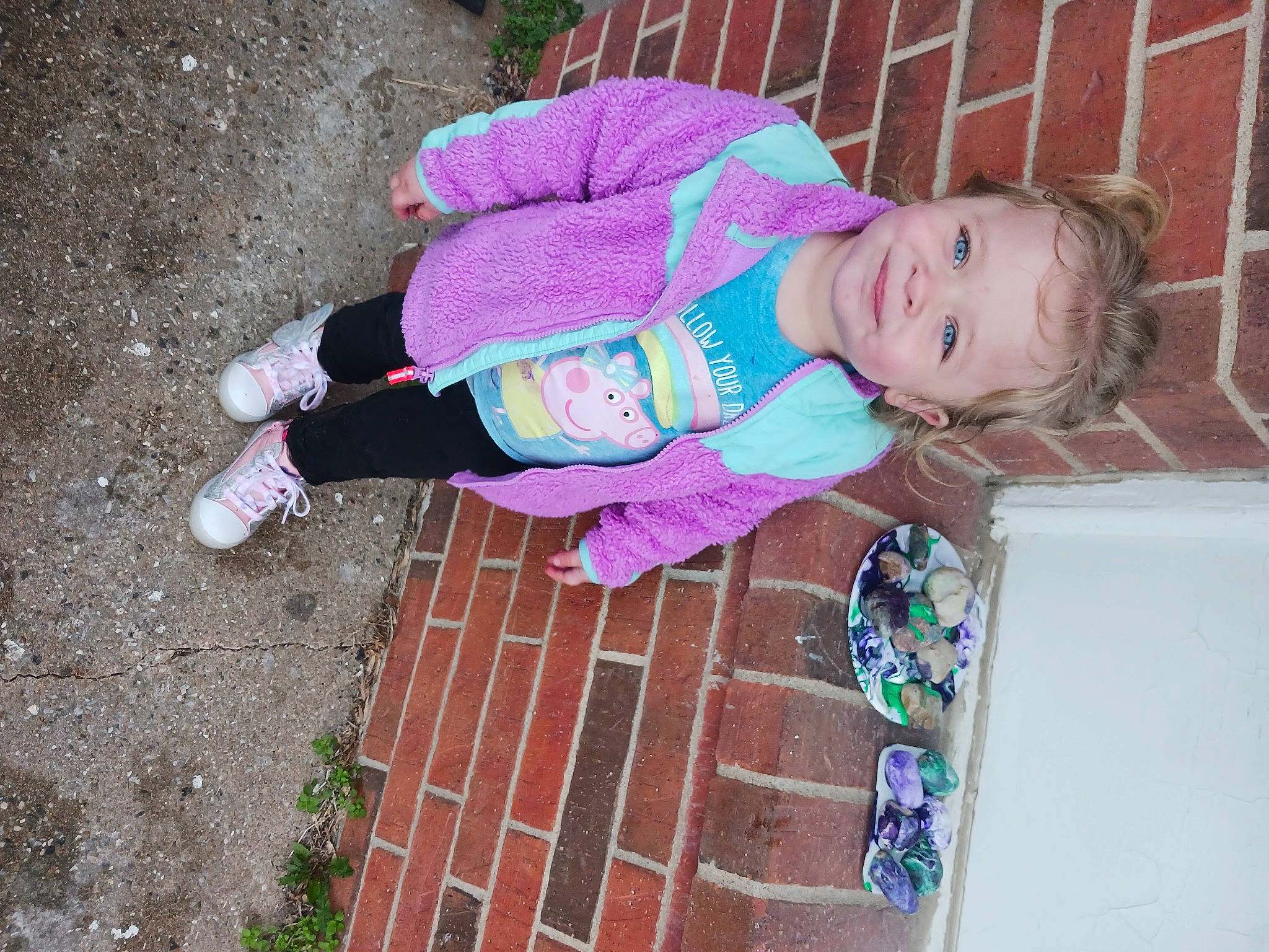 Tinsley joined the competition — help win amazing prizes! baby_toddler_clothing, brick, brickwork, child, fun, grass, human_leg, joy, magenta, pattern, person, pink, purple, road_surface, sidewalk, smile, soil, toddler