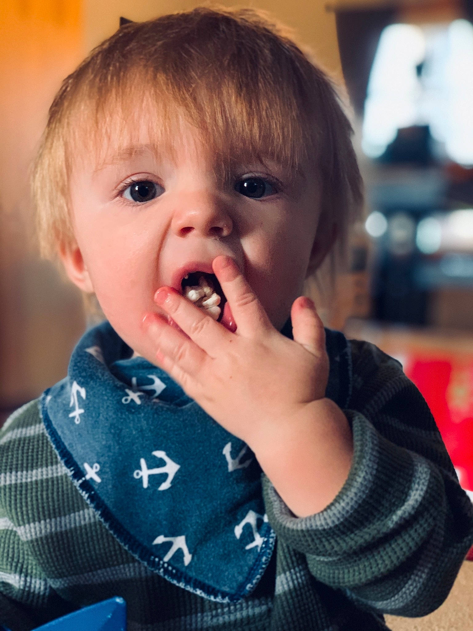 Huxley is registered to the contest to win money with this photo: baby, baby_toddler_clothing, biting, blond, brown_hair, cheek, child, eating, eye, eyelash, iris, lip, mobile_phone, nail, person, portable_communications_device, portrait_photography, sweater, taste, toddler
