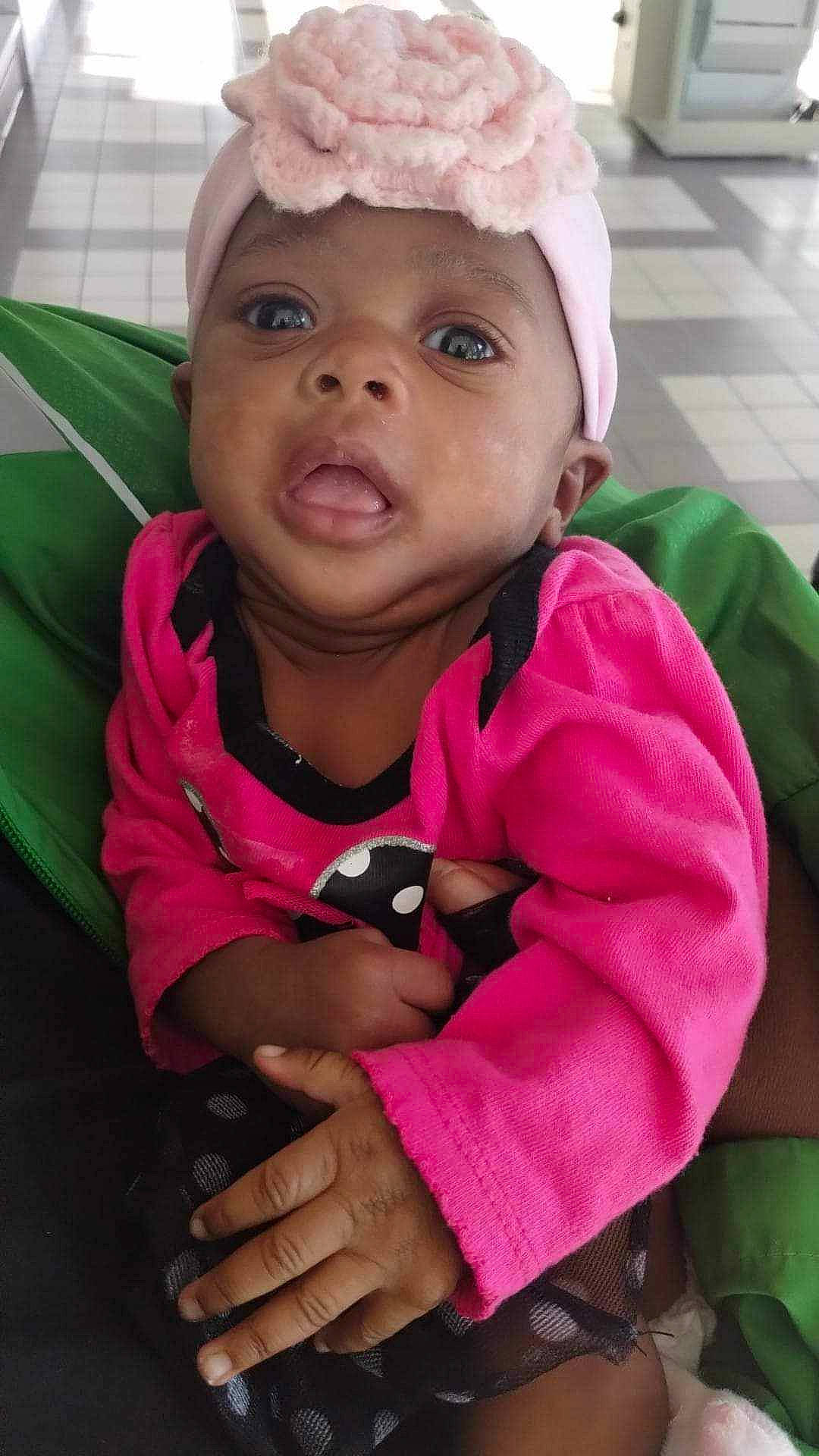 Amani is registered to the contest to win money with this photo: baby, baby_toddler_clothing, cap, cheek, cool, eyebrow, eyelash, facial_expression, fun, happy, headwear, iris, lip, magenta, mouth, nose, person, pink, purple, skin