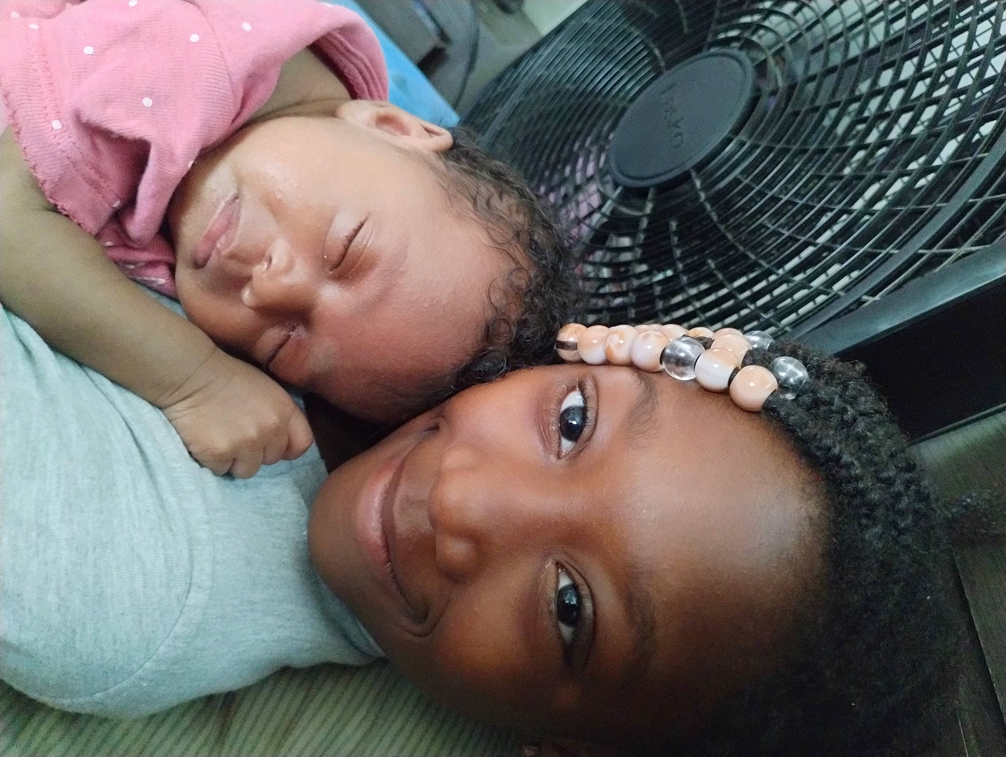 Amani is registered to the contest to win money with this photo: audio_equipment, cheek, child, comfort, eyelash, flash_photography, fun, grass, happy, home_appliance, joy, leisure, lip, mechanical_fan, mouth, nap, nose, person, portrait_photography, skin