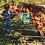 Palmer is registered to the contest to win money with this photo: animal, child, daytime, farm, floral_shirt, gate, girl, grass, horse, interaction, jeans, leaf, nature, outdoor, pet, rural, shadow, sneakers, sunlight, tree