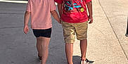 Palmer joined the competition — help win amazing prizes! child, children, holding_hands, sidewalk, outdoor, sunlight, shadow, casual_clothing, spiderman_shirt, shorts, shoes, walking, back_view, summer, people, urban, daytime, friends, friendship, siblings