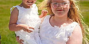 Palmer joined the competition — help win amazing prizes! child, children, girl, white_dress, outdoor, sunny, smile, glasses, holding, grass, field, happy, blonde_hair, braids, portrait, person, nature, fashion, footwear, daylight