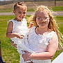 Palmer joined the competition — help win amazing prizes! child, children, girl, white_dress, outdoor, sunny, smile, glasses, holding, grass, field, happy, blonde_hair, braids, portrait, person, nature, fashion, footwear, daylight