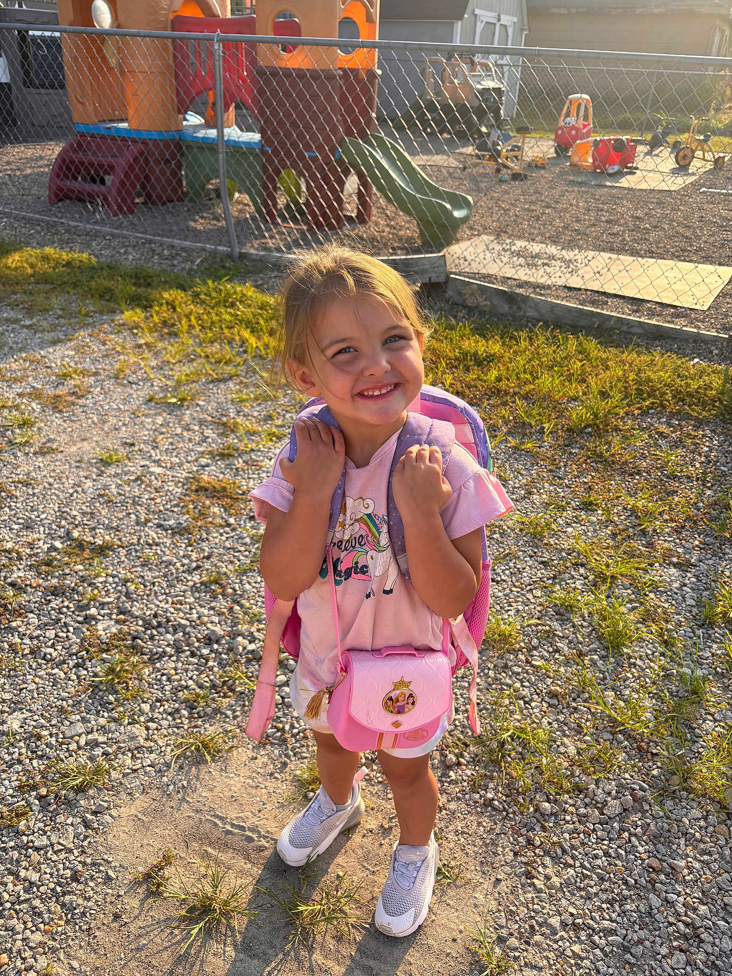 Palmer joined the competition — help win amazing prizes! child, girl, smile, backpack, pink_purse, playground, slide, fence, gravel, grass, sunlight, sneakers, shorts, tshirt, outdoor, daylight, happy, toy, play, person