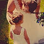 Palmer is registered to the contest to win money with this photo: bride, child, white_dress, flower_bouquet, grass, outdoor, sunlight, woman, girl, wedding, hairstyle, pigtails, dress, nature, celebration, holding, tender_moment, event, people, portrait