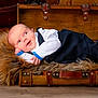 Armine participe au concours pour gagner de l'argent avec cette photo : baby, infant, suit, furry_blanket, vintage_suitcase, wooden_floor, old_trunks, portrait, cute, child, resting, indoors, cozy, small_hands, curious, lying_down, soft_texture, fashion, head_support, expression