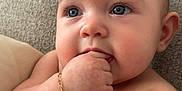 Hadley joined the competition — help win amazing prizes! baby, infant, blue_eyes, bracelet, cheeks, hand, couch, skin, closeup, portrait, fingertips, bare_chest, expression, comfortable, soft_texture, young_child, cute, curious, relaxed, indoors