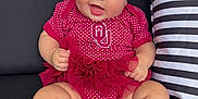 Hadley is registered to the contest to win money with this photo: baby, barefoot, blue_eyes, bow, child, couch, cute, happy, headband, indoor, infant, person, pillow, polka_dot, portrait, red_clothing, sitting, smiling, striped_pillow, tutu