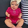 Hadley is registered to the contest to win money with this photo: baby, child, smiling, headband, bow, red_clothing, polka_dot, tutu, couch, pillow, striped_pillow, barefoot, happy, blue_eyes, indoor, infant, cute, sitting, portrait, person