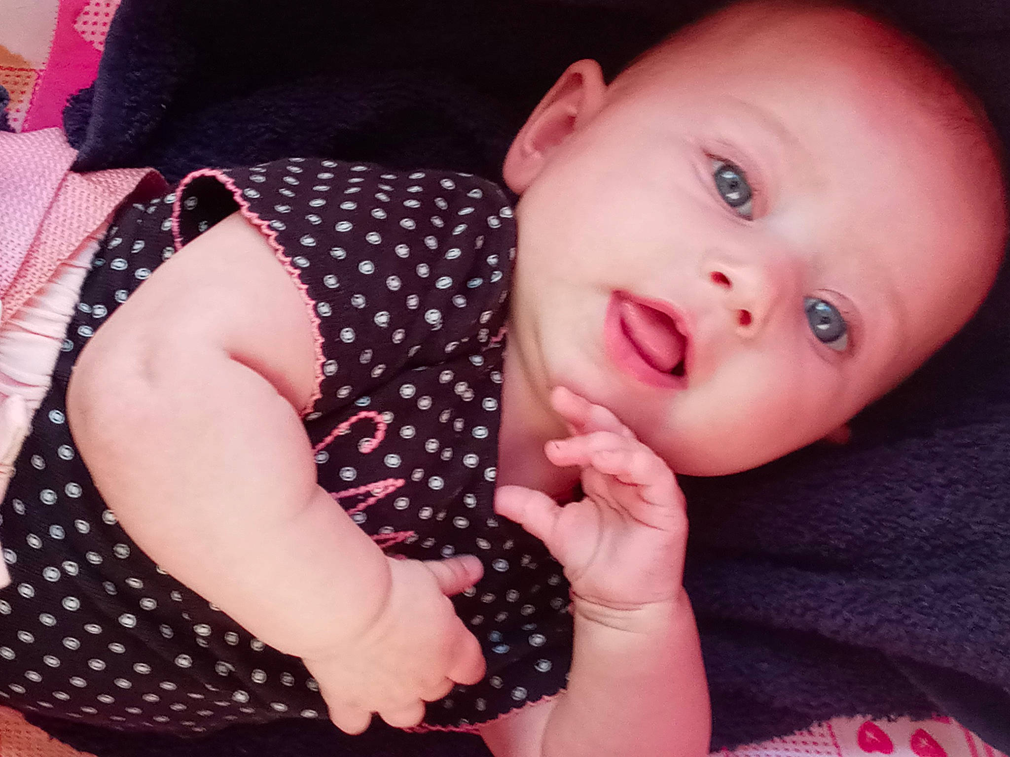 Khole is registered to the contest to win money with this photo: arm, baby_toddler_clothing, cheek, collar, eyelash, facial_expression, finger, gesture, hand, human_body, iris, lip, mouth, neck, nose, person, pink, product, skin, sleeve