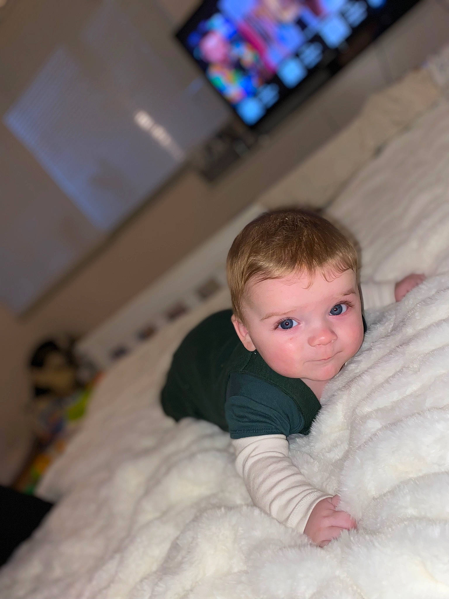 Henry is registered to the contest to win money with this photo: baby, baby_toddler_clothing, cheek, child, comfort, couch, flash_photography, flooring, fun, fur, gadget, happy, head, linens, person, portrait_photography, room, sitting, smile, toddler