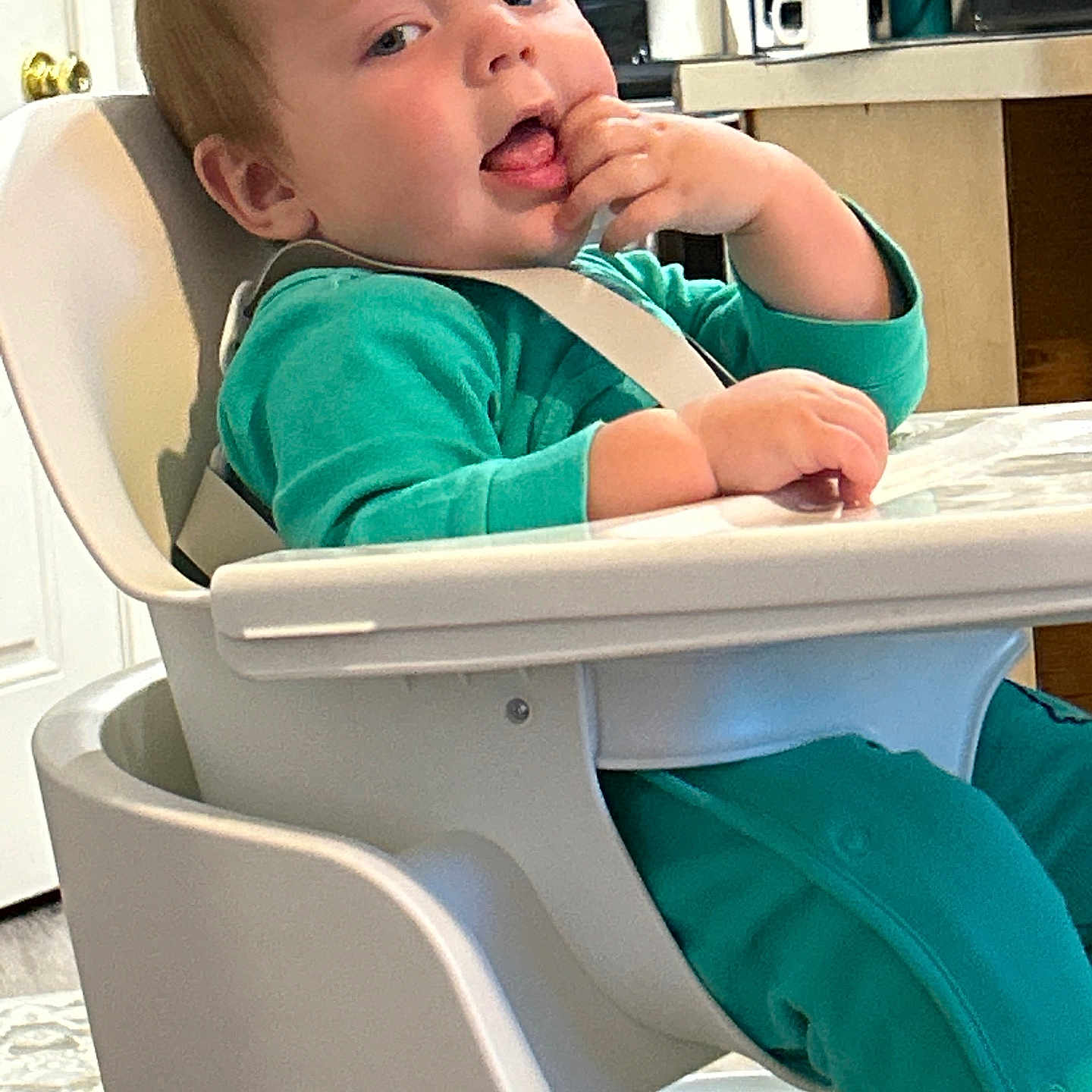 Waylon is registered to the contest to win money with this photo: baby, bodypart, chair, clothing, crib, cup, cutlery, face, finger, furniture, hand, head, highchair, infantbed, pants, person, photography, portrait, sitting, spoon