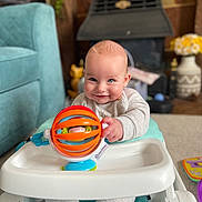Flynn joined the competition — help win amazing prizes! baby, child, walker, toy, smile, indoor, carpet, furniture, couch, foot, hand, face, clothing, playtime, floor, colorful, happy, cute, infant, person