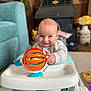 baby, child, walker, toy, smile, indoor, carpet, furniture, couch, foot, hand, face, clothing, playtime, floor, colorful, happy, cute, infant, person