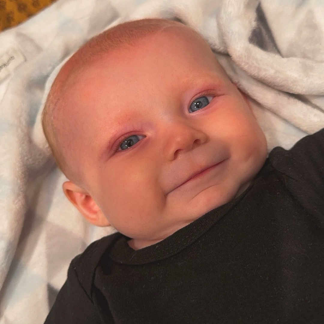 Ryder joined the competition — help win amazing prizes! baby, bed, bedroom, blanket, clothing, cushion, face, furniture, happy, head, homedecor, indoors, newborn, person, photography, portrait, quilt, sleeping, smile, t_shirt