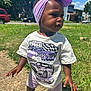 Mckenzie is registered to the contest to win money with this photo: toddler, child, outdoor, sidewalk, grass, headband, purple, tshirt, sneakers, sunny, daytime, person, standing, casual_clothing, suburban, greenery, shoes, young_child, portrait, curious