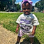 Mckenzie joined the competition — help win amazing prizes! toddler, child, outdoor, sunny, grass, sidewalk, headband, bow, tshirt, graphic_tshirt, race_car, shorts, sneakers, tongue_out, playful, smiling, person, daytime, urban, casual_clothing