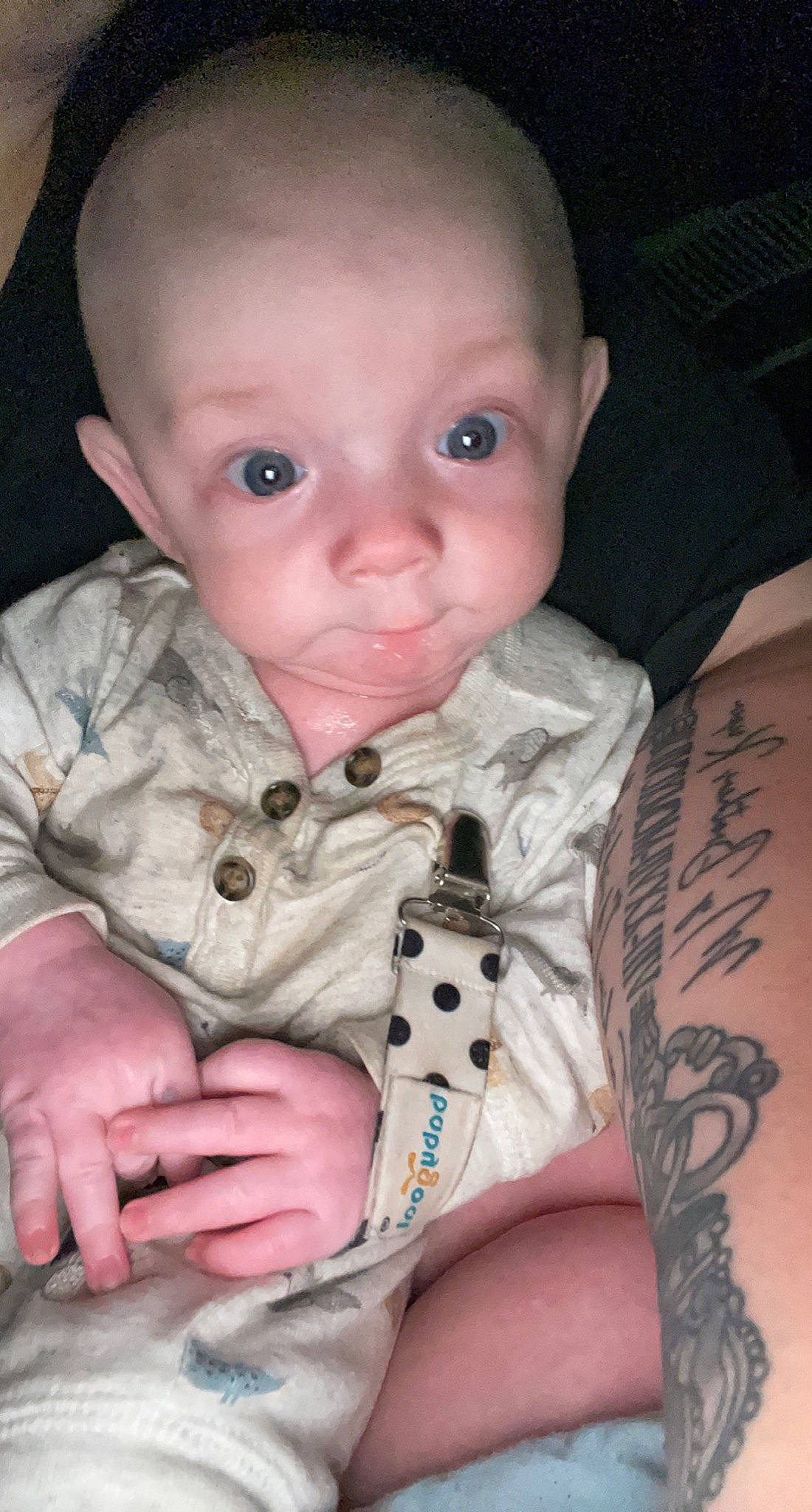Travis is registered to the contest to win money with this photo: baby, baby_toddler_clothing, cheek, comfort, dress_shirt, elbow, eyelash, finger, iris, joint, lip, mammal, mouth, neck, nose, person, skin, sleeve, temporary_tattoo, toddler