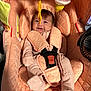 baby, balloon, blanket, car, car_interior, carseat, clothing, face, happy, head, hosiery, infantbed, machine, person, photography, smile, sock, transportation, vehicle, wheel