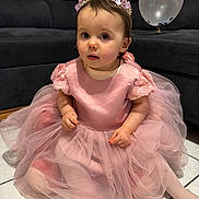 Lyana participe au concours pour gagner de l'argent avec cette photo : child, toddler, baby, princess, crown, pink_dress, tulle, tutu, sitting, sofa, balloon, indoor, tile_floor, portrait, curious_expression, party, sparkle, sock, celebration, cute