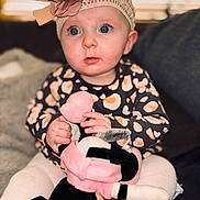 Daisy is registered to the contest to win money with this photo: accessories, baby, bodypart, cap, clothing, couch, face, finger, flower, furniture, hand, hat, head, newborn, person, photography, plant, portrait, rose, toy