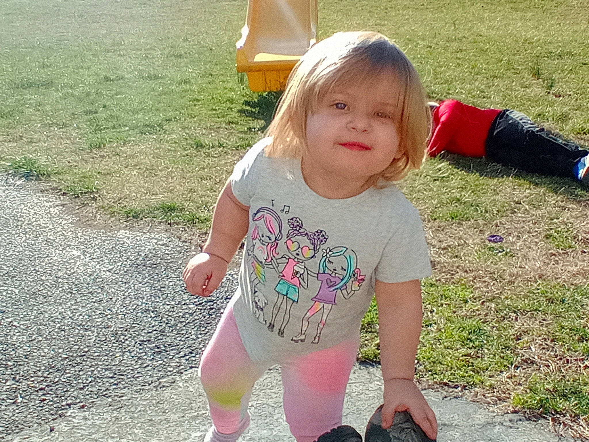 Gabriella is registered to the contest to win money with this photo: baby_toddler_clothing, face, finger, fun, grass, hair, happy, head, human_body, joint, joy, leaf, leg, leisure, people_in_nature, person, public_space, sleeve, smile, summer