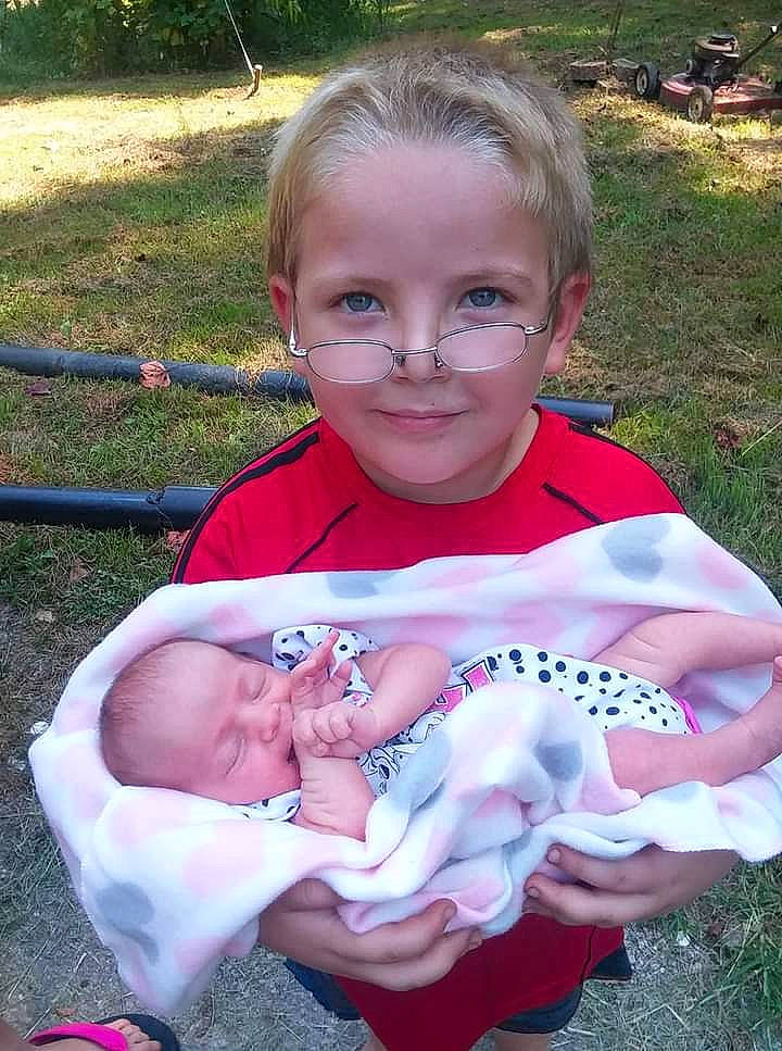 Eric Jr is registered to the contest to win money with this photo: baby, baby_products, baby_toddler_clothing, child, fun, garden, grass, happy, iris, joy, leisure, people_in_nature, person, photograph, pink, plant, recreation, sitting, smile, spring