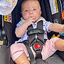 Charlotte joined the competition — help win amazing prizes! baby, child, car_seat, infant, safety_harness, blue_eyes, pink_pants, white_onesie, fingers_in_mouth, cute, indoors, close_up, seat_belt, toy, child_safety, infant_clothing, portrait, person, young_child, seat