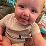 Charlotte joined the competition — help win amazing prizes! baby, tongue, close_up, indoor, furniture, plant, couch, shirt, child, face, cute, person, smile, legs, arm, home, infant, toddler, playful, expression