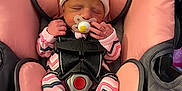 Charlotte is registered to the contest to win money with this photo: newborn, baby, sleeping, car_seat, pacifier, pink, white_hat, onesie, infant, child, safety_harness, warning_label, fabric, seat, comfort, cute, small_hands, indoor, resting, peaceful