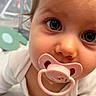 Jade participe au concours pour gagner de l'argent avec cette photo : baby, blue_eyes, child, close_up, crawling, curious, cute, expression, face, hair, head, indoor, infant, mouth, pacifier, person, skin, soft_light, white_clothing, young