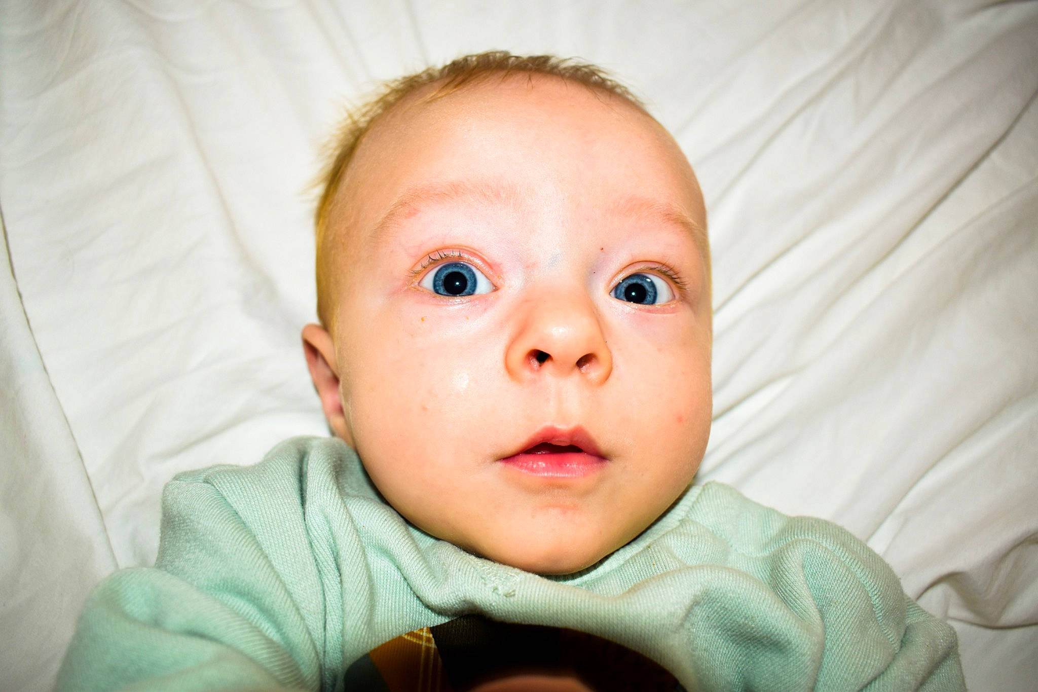 Kolson joined the competition — help win amazing prizes! baby, baby_toddler_clothing, cheek, child, comfort, ear, eyelash, flash_photography, fun, gesture, happy, iris, linens, mouth, nose, person, room, skin, smile, thumb