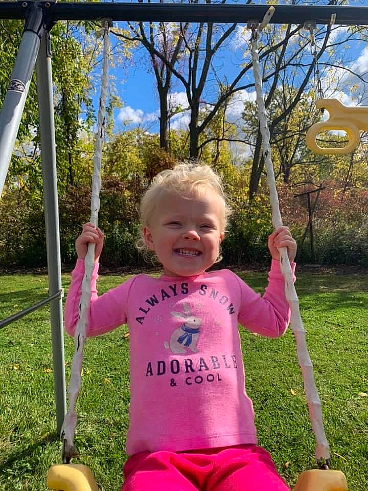 Sophia is registered to the contest to win money with this photo: baby, baby_toddler_clothing, balance, child, finger, happy, human_settlement, joy, laugh, outdoor_play_equipment, person, play, playground, public_space, spring, summer, swing, thumb, toddler, toy