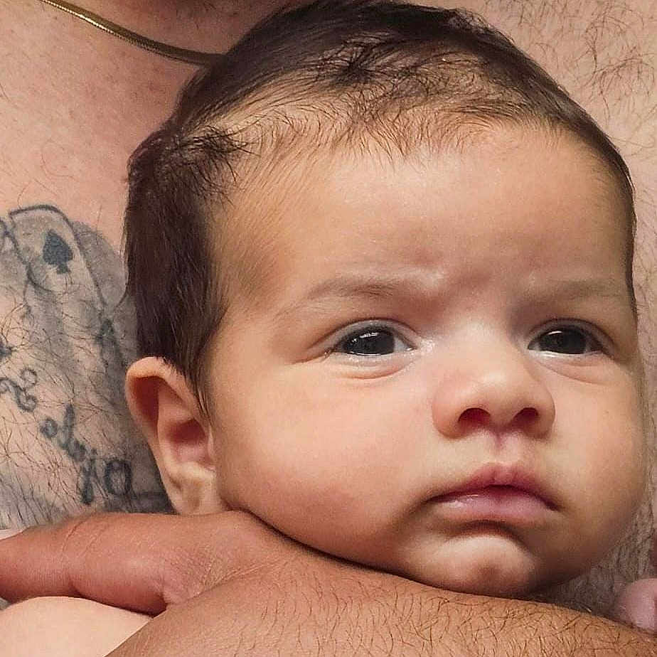 Lucas Ramos joined the competition — help win amazing prizes! adult, baby, child, closeup, cute, expression, face, fingers, hair, hand, head, holding, human, infant, looking, newborn, person, portrait, skin, tattoo