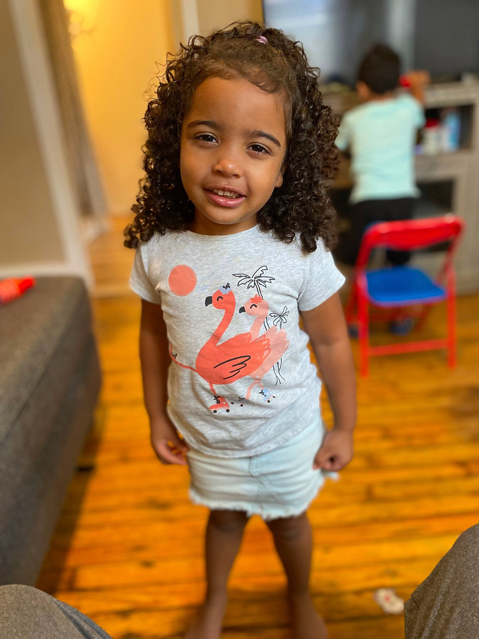 Lailani is registered to the contest to win money with this photo: beauty, chair, cheek, child, event, fashion_design, flooring, fun, hairstyle, happy, joy, person, ringlet, room, sitting, sleeve, smile, standing, t_shirt, toddler