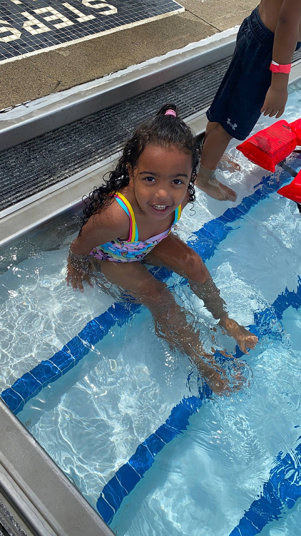 Lailani is registered to the contest to win money with this photo: aqua, azure, bathing, child, chute, fun, happy, indoor_games_and_sports, joy, leisure, leisure_centre, nonbuilding_structure, person, play, recreation, smile, swimmer, swimming_pool, swimwear, toddler