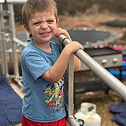 Lamar joined the competition — help win amazing prizes! child, boy, smiling, outdoor, railing, mickey_mouse, tshirt, red_shorts, playground, trampoline, grass, daylight, casual_clothing, person, young_child, happy, fun, summer, metal, background