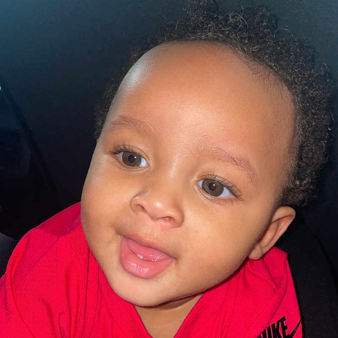 Jayceon is registered to the contest to win money with this photo: accessories, baby, bodypart, clothing, cushion, face, hair, happy, head, homedecor, laughing, mouth, person, photography, portrait, selfie, shirt, smile, t_shirt, teeth