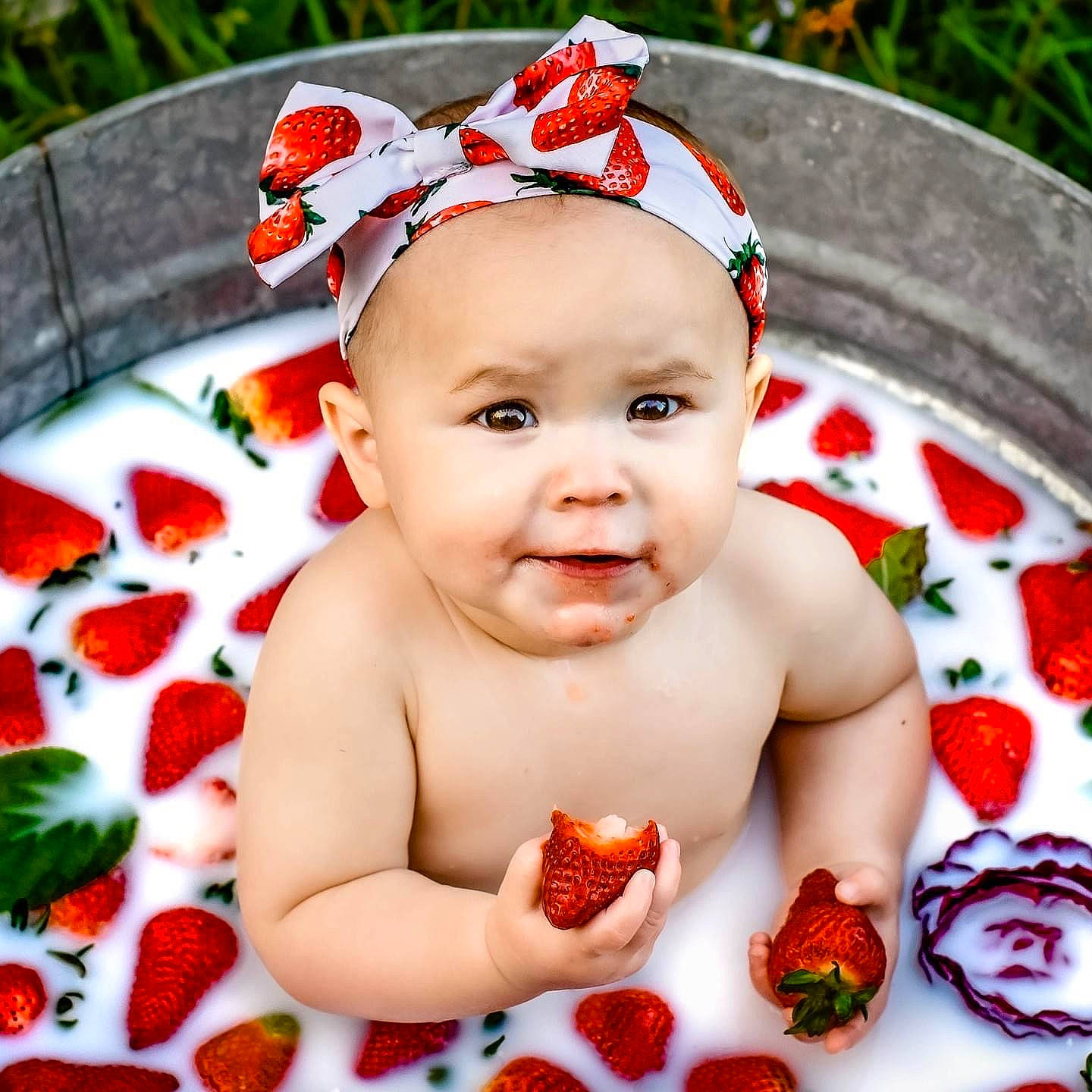 Charleigh is registered to the contest to win money with this photo: baby, bathing, cheek, child, eye, finger, fruit, grass, happy, leaf, nail, natural_foods, person, plant, product, red, skin, smile, sweetness, toddler