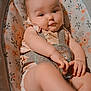 Harley is registered to the contest to win money with this photo: baby, infant, child, seat, straps, floral_pattern, cute, kicking, diaper, smiling, hands, legs, indoor, comfort, soft_lighting, face, person, young, plush, resting