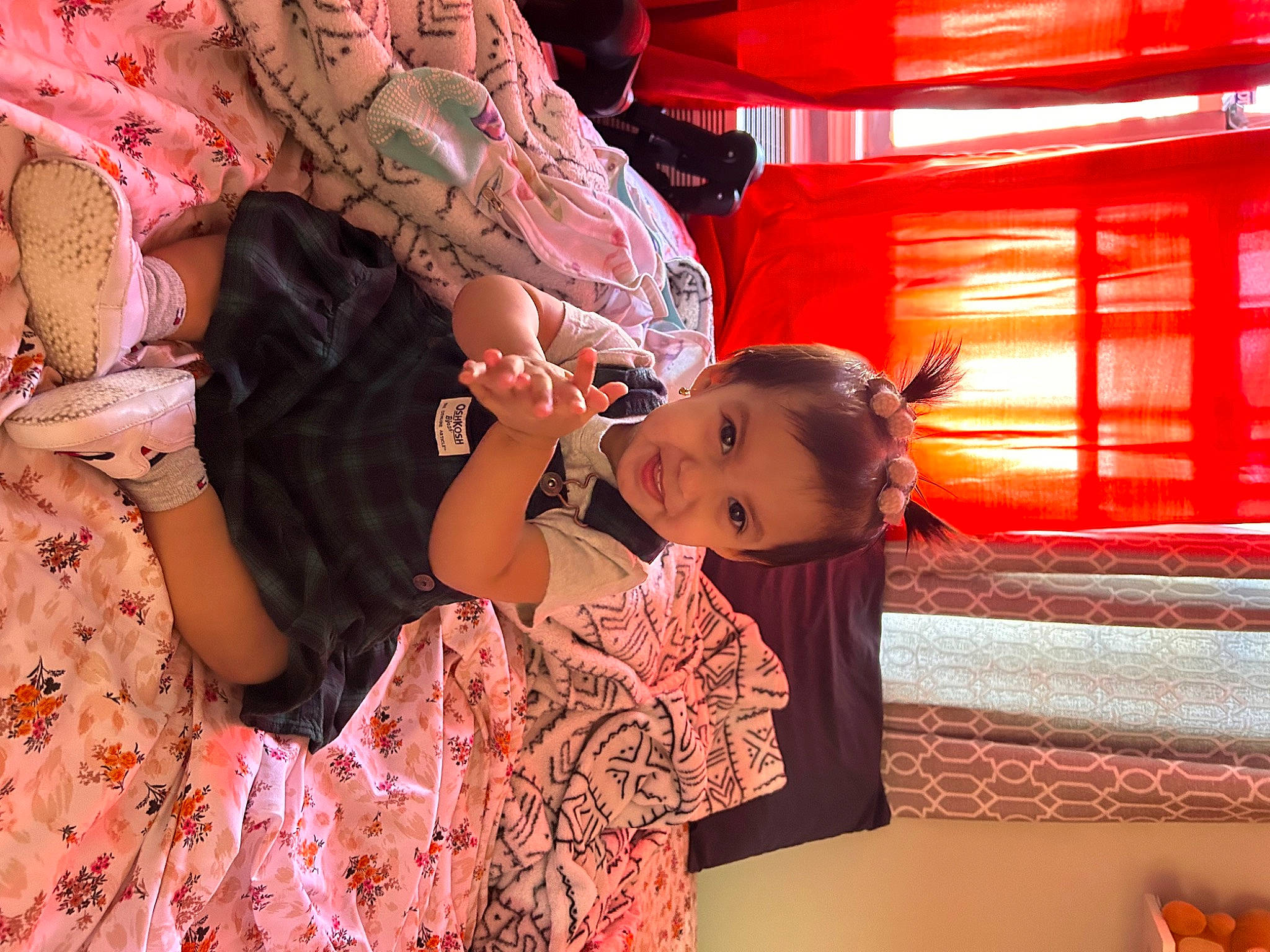 Amada is registered to the contest to win money with this photo: baby, baby_toddler_clothing, cheek, child, event, facial_expression, fun, happy, joy, leisure, magenta, pattern, peach, person, pink, room, sitting, skin, temple, textile