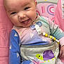 baby, smiling, onesie, adidas, pink, rainbow, animal_print, baby_seat, happy, tongue_out, infant, cute, clothing, child, playful, colorful, seat, indoors, face, hand