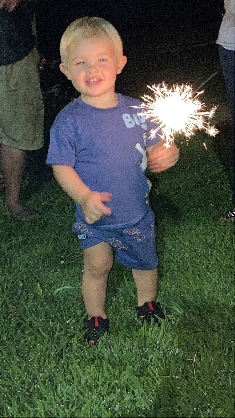 Jordan is registered to the contest to win money with this photo: american_football, child, diwali, electric_blue, event, fireworks, fun, grass, happy, holiday, joy, new_year, new_years_day, party_supply, people_in_nature, person, recreation, sandal, shorts, smile