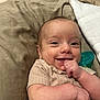 Dakota is registered to the contest to win money with this photo: baby, smile, infant, face, hand, pacifier, bed, blanket, clothing, skin, cute, child, portrait, lying_down, happy, young, indoors, comfort, closeup, expression