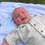 Kaesyn joined the competition — help win amazing prizes! baby, blanket, child, cute, face, grass, happy, head, infant, lying_down, outdoor, peaceful, portrait, relaxed, shirt, skin, smiling, soft_light, striped_clothing, toddler
