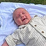baby, blanket, child, cute, face, grass, happy, head, infant, lying_down, outdoor, peaceful, portrait, relaxed, shirt, skin, smiling, soft_light, striped_clothing, toddler