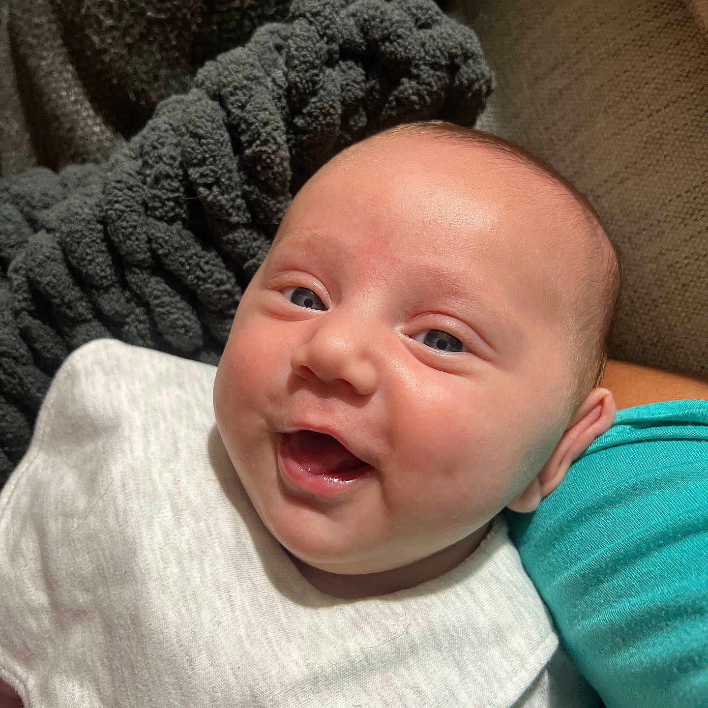 Kaesyn joined the competition — help win amazing prizes! baby, blanket, child, closeup, clothing, cute, fabric, face, happy, human, indoors, infant, joy, person, portrait, sitting, skin, smile, texture, warmth