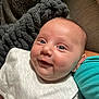 Kaesyn is registered to the contest to win money with this photo: baby, bib, blanket, blue, cheeks, closeup, clothing, couch, cute, eyes, face, happy, indoors, infant, person, portrait, skin, smile, texture, white